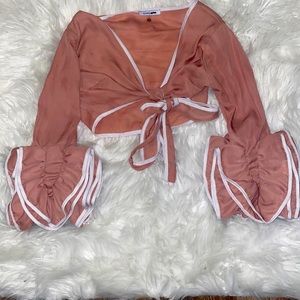Fashion Nova crop top. It ties in the front and has wide sleeves.